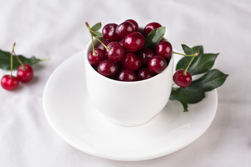 Fresh cherries in bowl on table