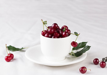 Fresh cherries in bowl on table
