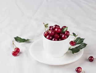 Fresh cherries in bowl on table