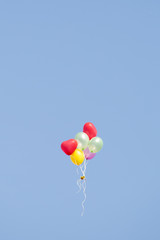 Plakat Bunch of colorful balloons in the background blue sky