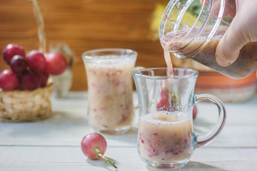 Grape smoothie over the white table.