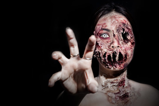 horrible scary zombie girl on black background with copyspace