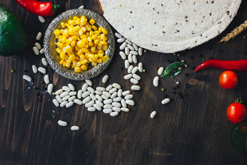 Obraz na płótnie Canvas Mexican food - tortilla with vegetables, corn and beans.