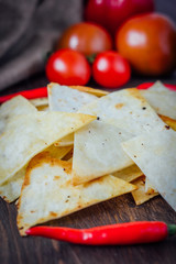 Organic mexican snack - nachos - corn chips with vegetables.
