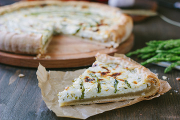 Piece of delicious asparagus pie on list of parchment.