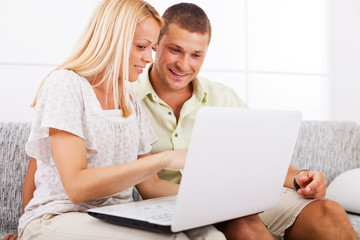 Young couple using laptop.