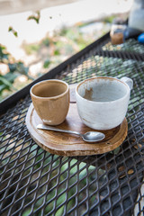 Used coffee cup on wooden board