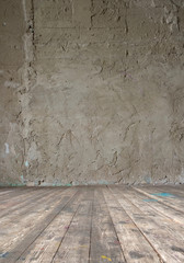 Bright vintage studio interior with wooden floor and raw concrete wall