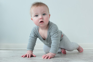 Naklejka premium Baby crawls on the floor