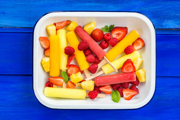 Bright Ice Popsicles made from Lemon, Pineapple, Berries © manuta