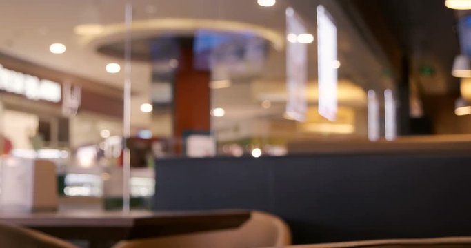 Anonymous crowd of people walking along cafe window. Shallow depth of field. People defocused footage. Vintage grading.