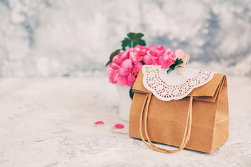 Paper bag with flowers. Present concept. Cute gift for mothers day