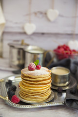 delicious pancakes on wooden table with fruits