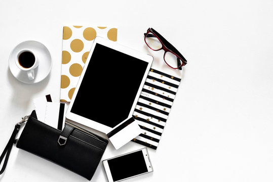 Women's Office Desk On White Background Touch Pad Tablet With Gold Stylish Books Black Wallet Credit Cards, Top View