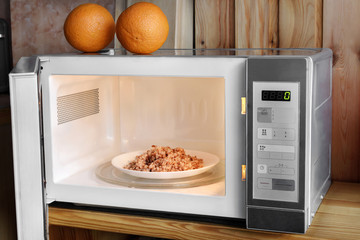 Microwave oven on a wooden background