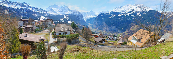 Panorama of green Wengen village and snowy Lauterbrunnen Valley, Switzerland