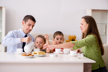 Happy family having breakfast together at home