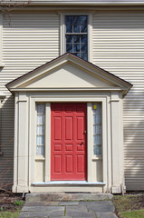 House with red door and window off center
