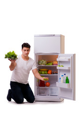 Man next to fridge full of food