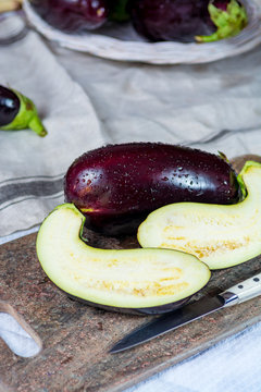 Ripe violet eggplants on granite plank  - harvest, ready to cook