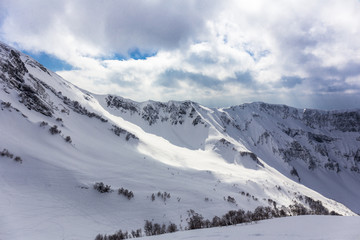 Fototapeta na wymiar Scenery top view on winter mountains from ski resor