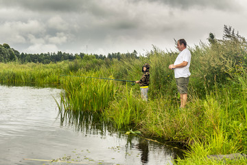 Fototapeta na wymiar Father and little son fishing