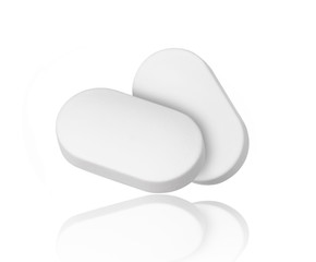 close-up of two pills isolated on white background