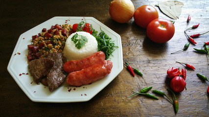 Barbecue and calabrese and fresh vegetables on aged background