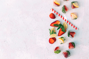 Fototapeta na wymiar Fresh homemade ice cubes with fruits. Summer fresh drink