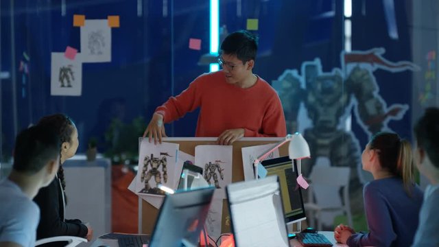  Young Asian video game designers in a team meeting