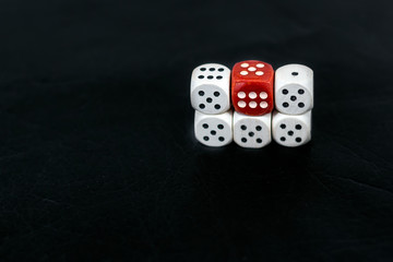 Dice five fives and red six on a black background