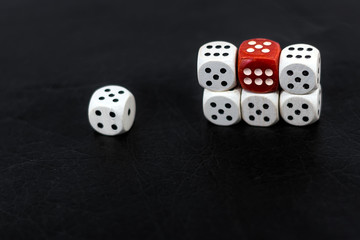 Dice six units and a red six on a black background