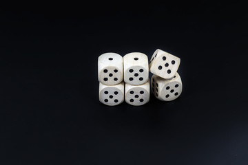 Dice six fives on a black matte background