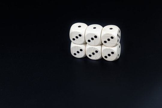 Dice six triples on a black background