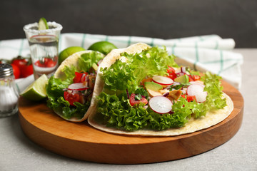 Delicious tacos with tequila lime chicken on wooden board