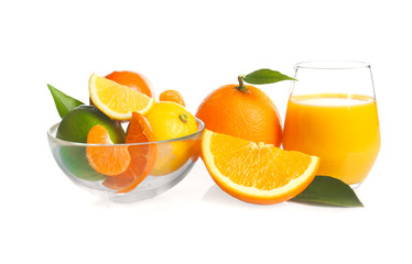 Glass of fresh juice and bowl with citrus fruits on white background