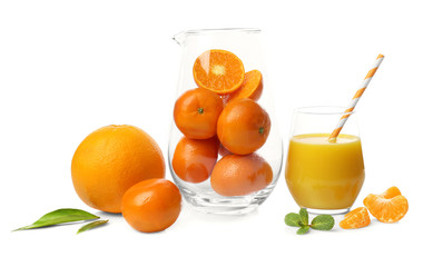 Glass of fresh juice and jar with tangerines on white background
