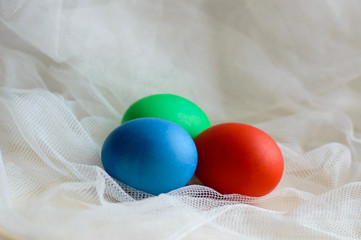 Colored eggs colored on Easter for the lace. Fun colored eggs painted manually. Handmade food on a subtle texture.