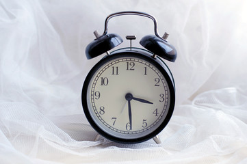 Alarm clock with beep. Vintage round mechanical watch. The time in retro style. The device, which...
