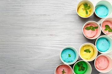 Ice cream collection in paper cups on wooden background