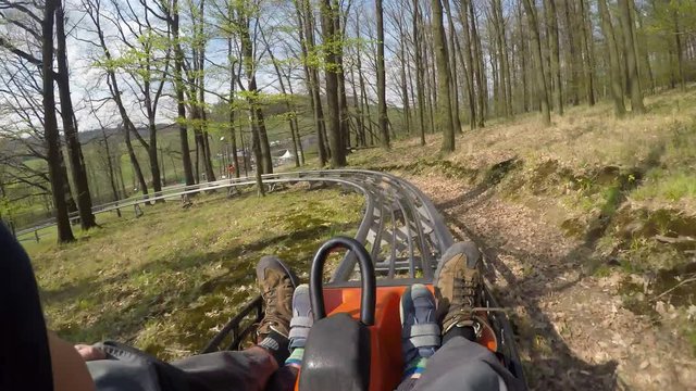 Fun on the bobsleigh track.
Father and son enjoy bobsled rides.
