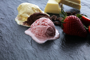 three scoops of ice cream - vanilla, strawberry and chocolate