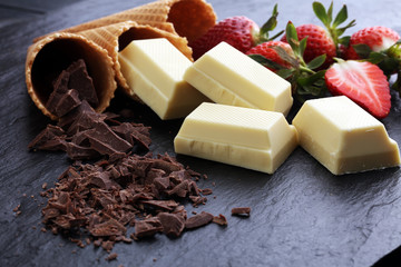 ice cream cones with white chocolate block and dark chocolate rasp and strawberries