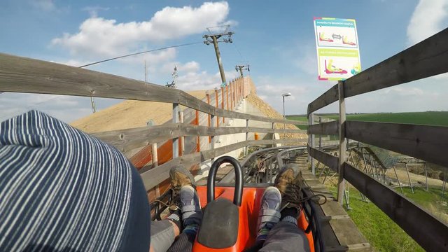 Fun on the bobsleigh track.
Father and son enjoy bobsled rides.