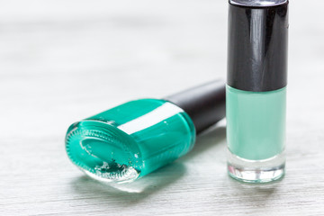 collection of nail polish on white desk background top view mock up