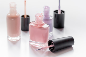 collection of nail polish on white desk background