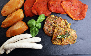 Selection of marinaded meat for grilling and sausages