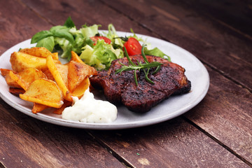 Grilled steaks, baked potatoes and salad