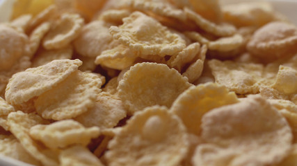 Corn flakes in white bowl. Close up view