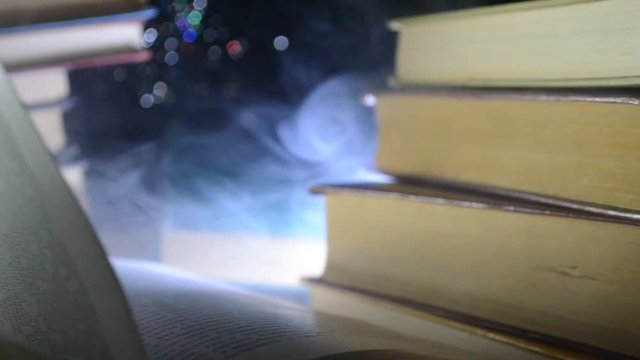 Many old books in a stack. Knoledge concept. Books on a dark background with smoke elements. Bewitched book in center. Glasswatch